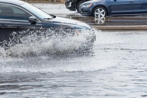 A vehicle driving through a flooded street in Texas