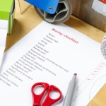 A,House,Moving,Checklist,On,A,Table,,Surrounded,By,Labels,