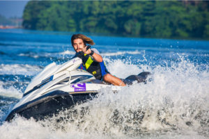 A man driving a jetski on the water.