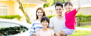 Asian family in front of house