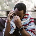 A man fighting his auto insurance company on the phone.