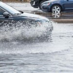A vehicle driving through a flooded street in Texas
