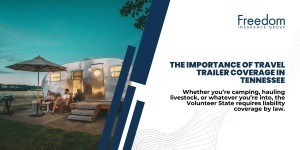 A couple sitting outside of their travel trailer at dusk.