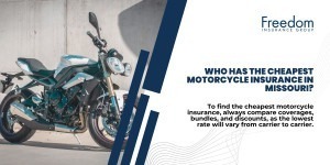 A motorcycle parked on a sidewalk in front of a concrete wall.